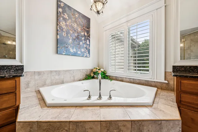a bathroom with bathtub and window