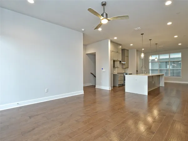 an open space with kitchen view and a refrigerator