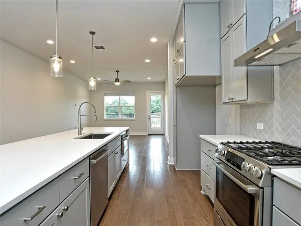 a kitchen with a stove and a sink