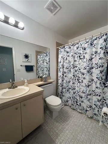 a bathroom with a sink toilet and mirror