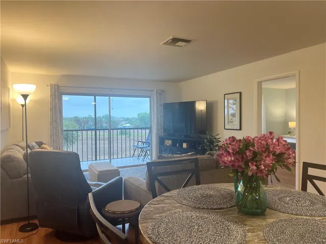 a dining room with furniture and wooden floor