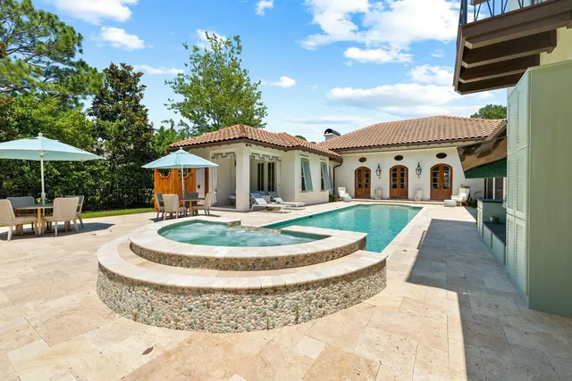 a view of backyard with outdoor seating and green space