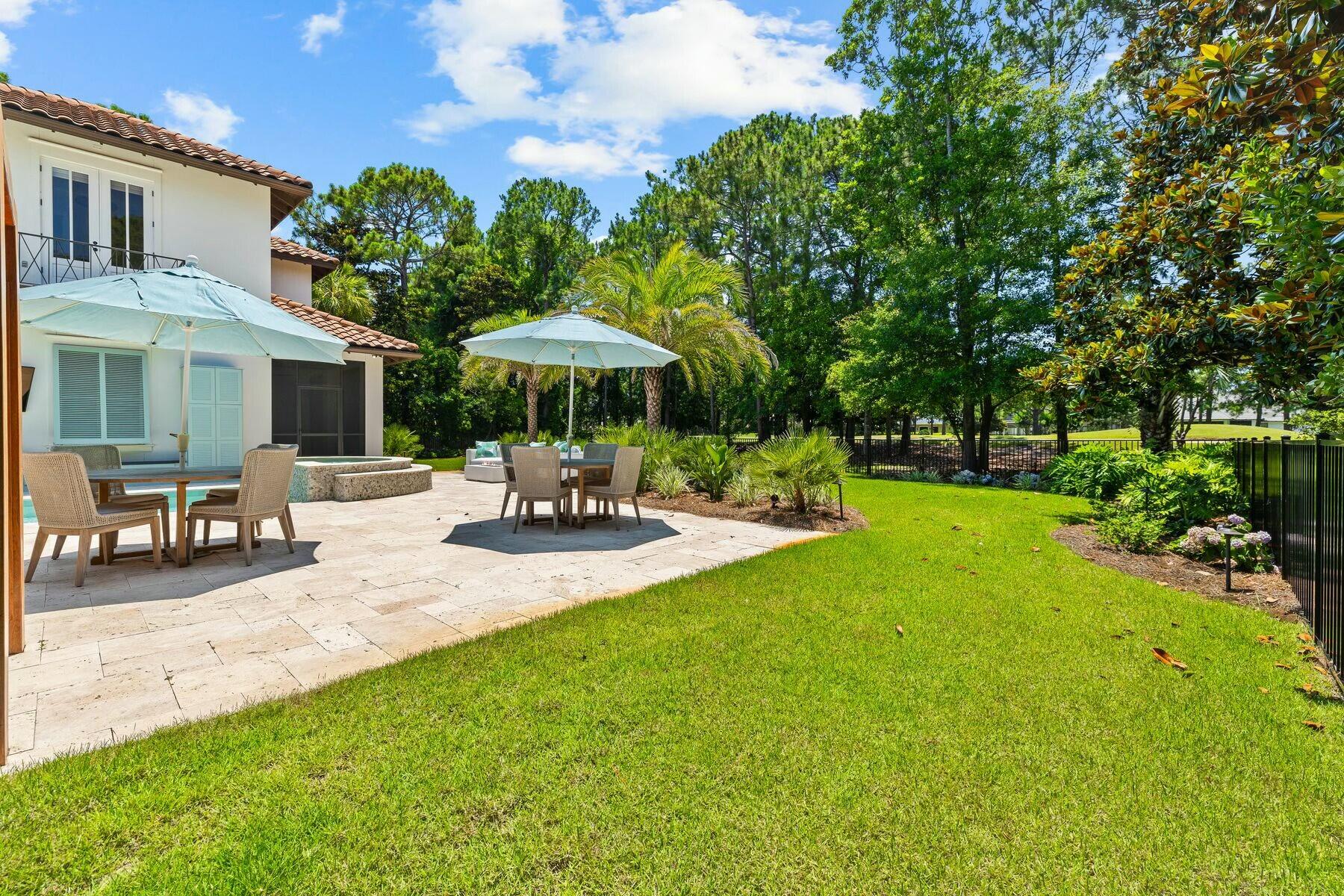 3121 Merion Drive Miramar Beach, FL 32550 - Photo 32 of 54 a view of a patio with table and chairs under an umbrella