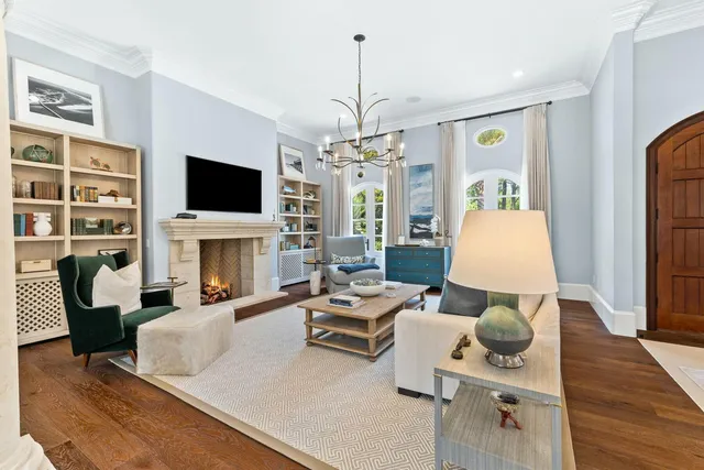 a living room with furniture a fireplace and a flat screen tv