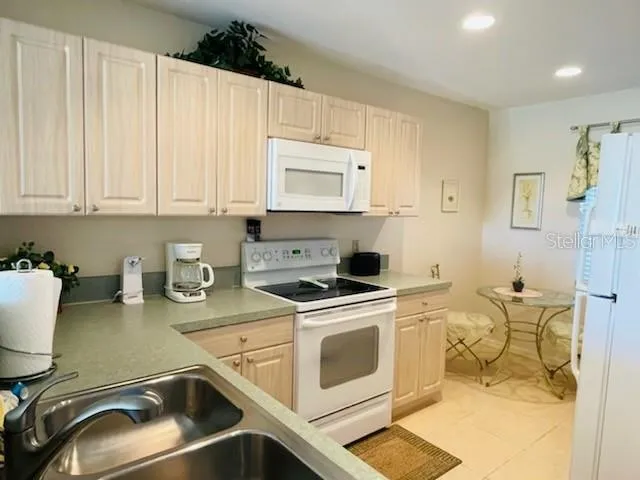 a kitchen with a stove a sink and a microwave
