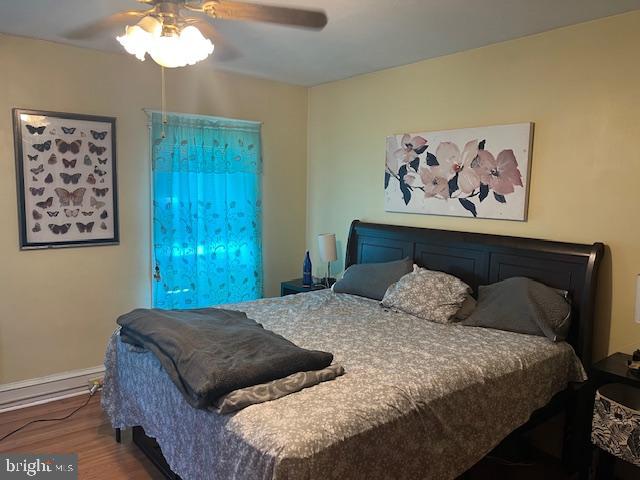 122 Arlington Street Reading, PA 19611 - Photo 13 of 15 a bedroom with a bed and a chandelier