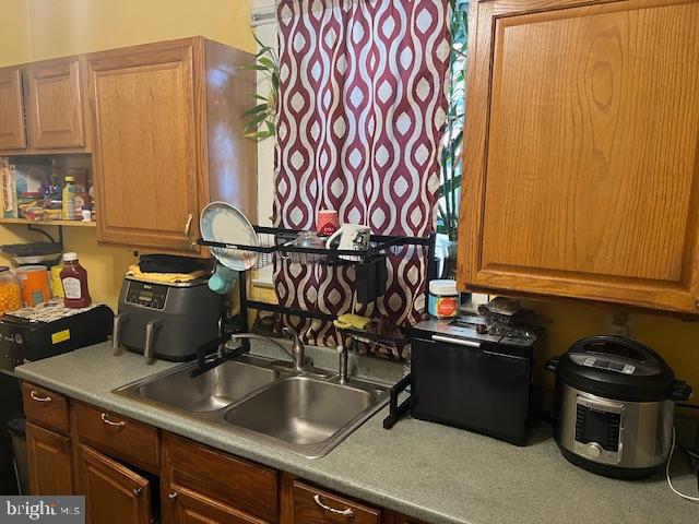 122 Arlington Street Reading, PA 19611 - Photo 9 of 15 a kitchen with a sink and a stove with wooden floor