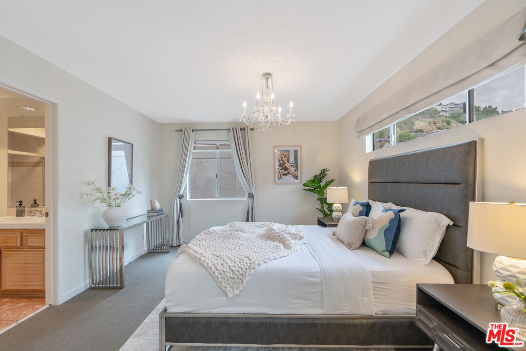 2131 Griffith Park Boulevard Los Angeles, CA 90039 - Photo 34 of 42 a bedroom with a large bed and a chandelier