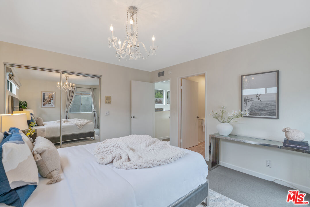 2131 Griffith Park Boulevard Los Angeles, CA 90039 - Photo 35 of 42 a bedroom with a large bed and a chandelier