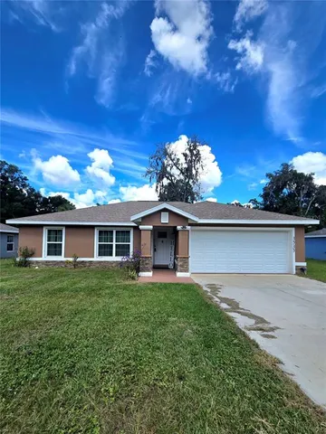 a front view of house with yard and green space