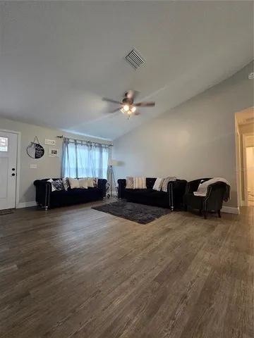a view of a livingroom with furniture and a window