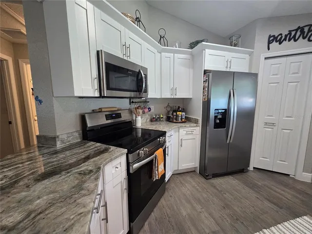 a kitchen with a sink stove and refrigerator