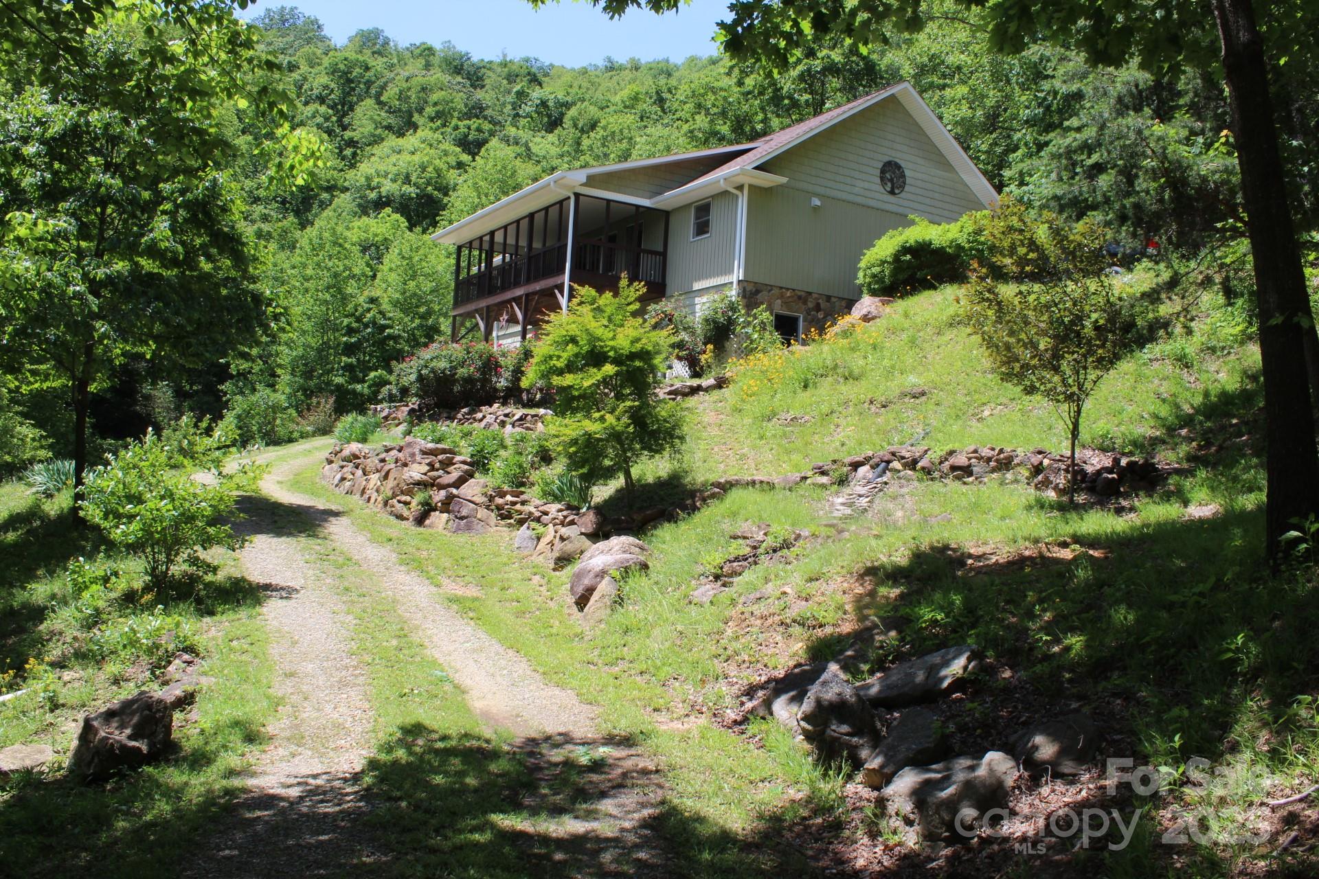 985 Roberson School Road Moravian Falls, NC 28654 - Photo 6 of 48 a backyard of a house with a yard and lake