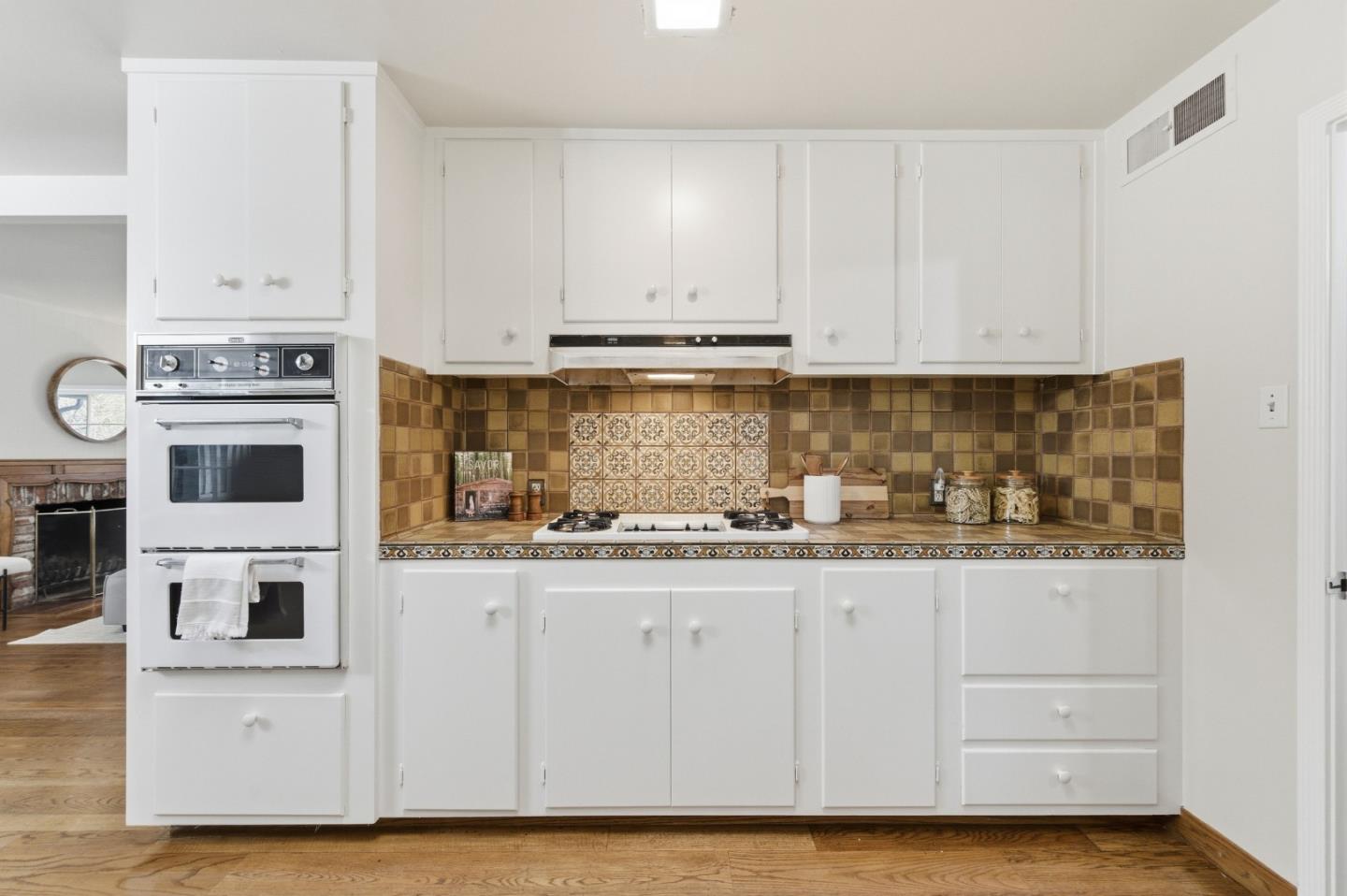 1698 Cordilleras Road Redwood City, CA 94062 - Photo 12 of 44 a kitchen with stainless steel appliances granite countertop a stove and white cabinets