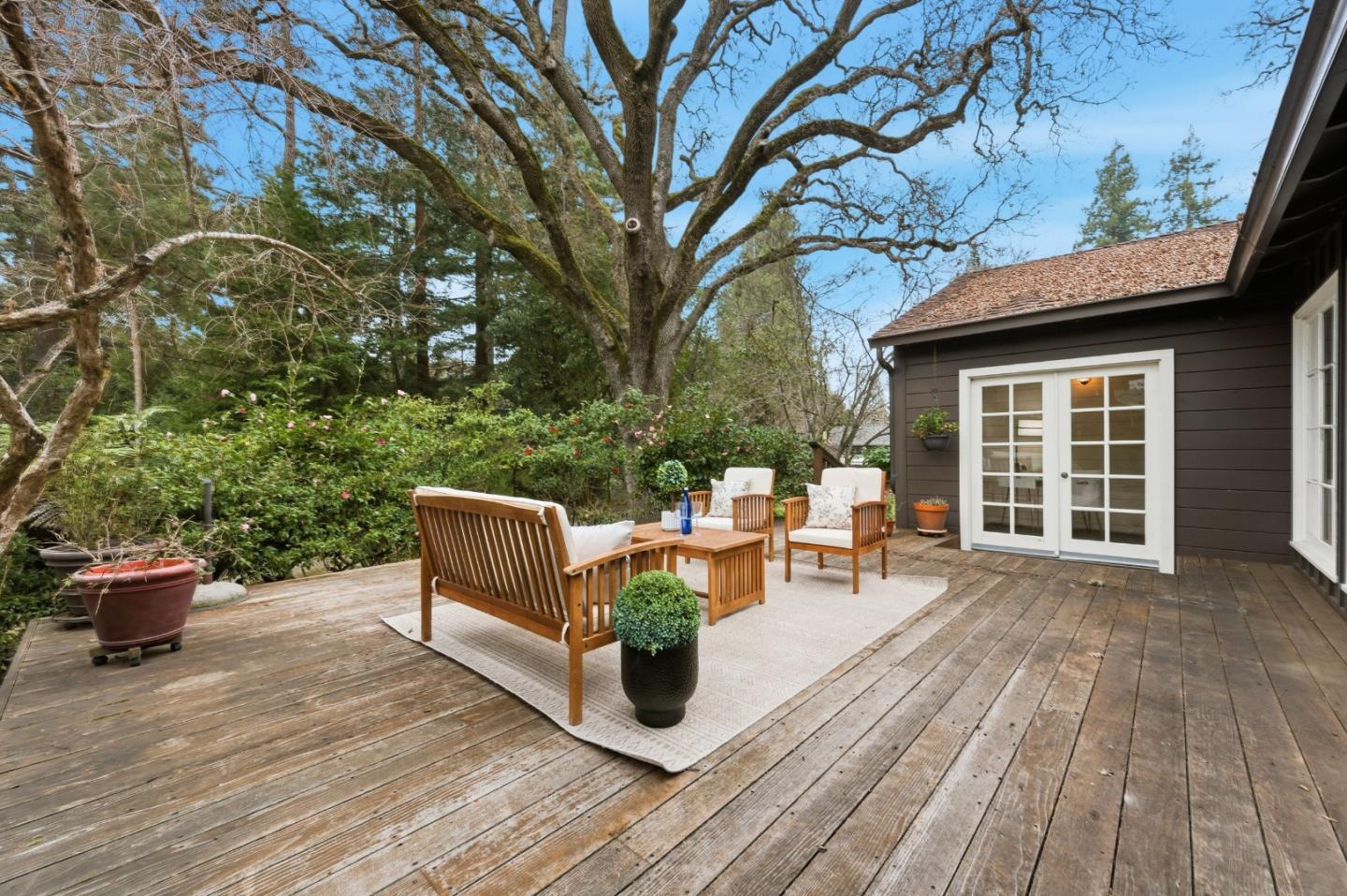 1698 Cordilleras Road Redwood City, CA 94062 - Photo 29 of 44 a view of a patio with table and chairs and wooden floor