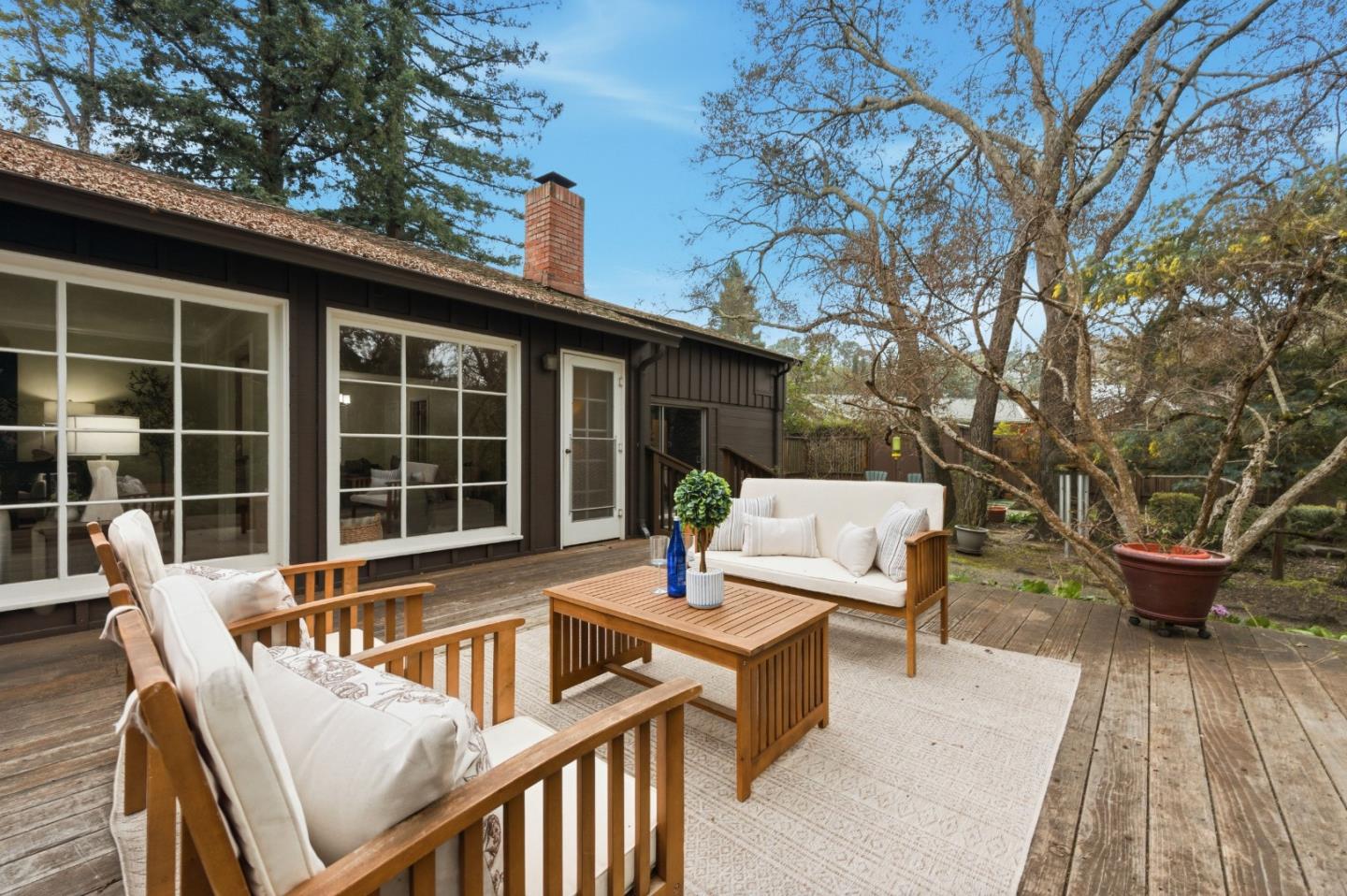 1698 Cordilleras Road Redwood City, CA 94062 - Photo 30 of 44 a view of a patio with couches chairs and wooden floor