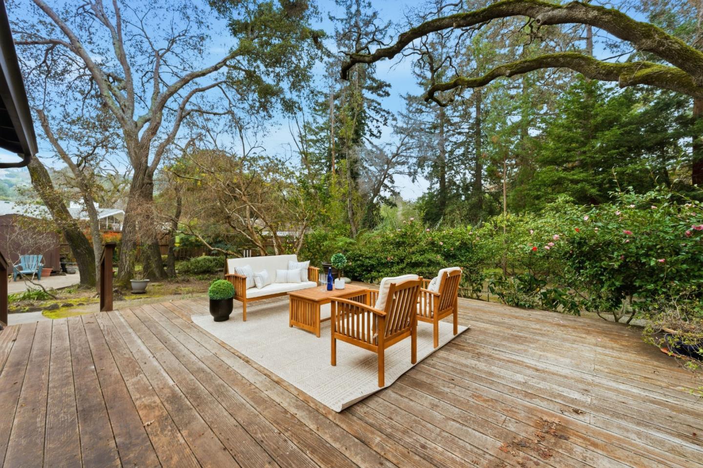 1698 Cordilleras Road Redwood City, CA 94062 - Photo 31 of 44 a view of a roof deck with couches and wooden fence