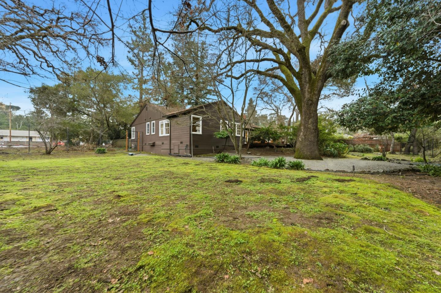 1698 Cordilleras Road Redwood City, CA 94062 - Photo 36 of 44 a yellow house in middle of the forest