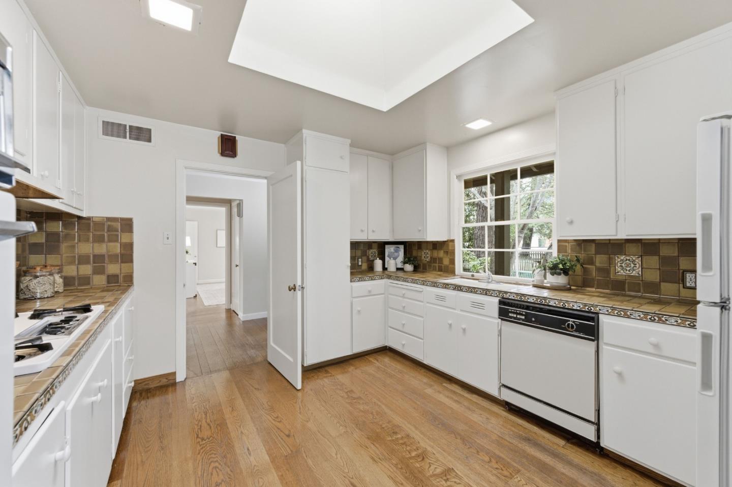 1698 Cordilleras Road Redwood City, CA 94062 - Photo 10 of 44 a kitchen with granite countertop a stove and a sink