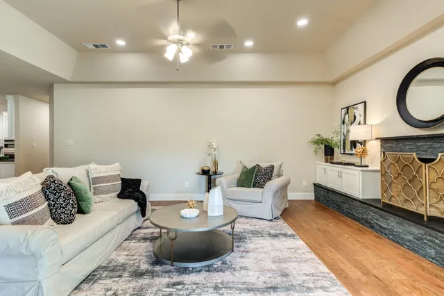 a living room with furniture a rug and a chandelier