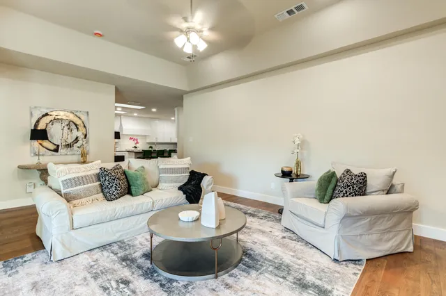 a living room with furniture and a view of kitchen
