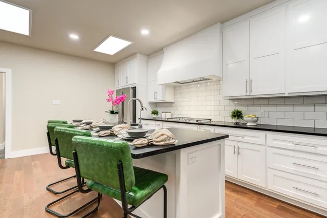 a kitchen with a sink cabinets and wooden floor