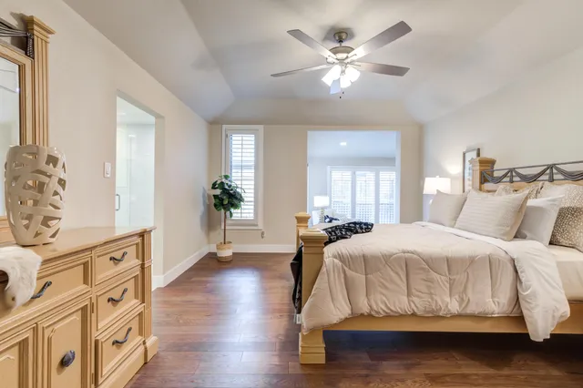 a bedroom with a large bed and a chandelier