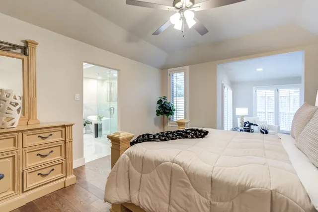 a bedroom with a large bed and a chandelier
