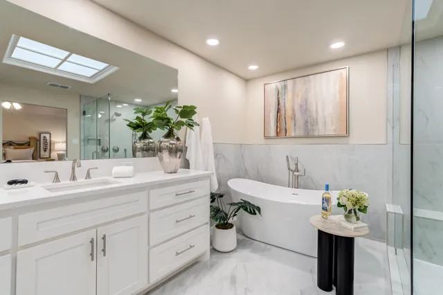 a bathroom with a sink mirror and a bathtub