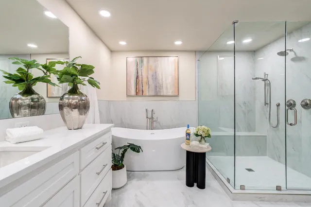 a bathroom with a shower sink vanity granite and toilet