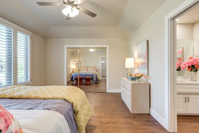 a spacious bedroom with a bed and a chandelier