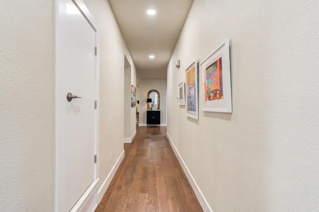 a view of a hallway with wooden floor