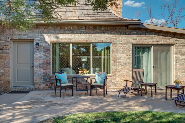 a view of a house with backyard porch and sitting area