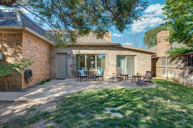 a front view of house with yard and outdoor seating