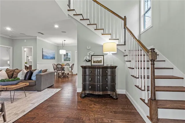a living room with furniture and stairs