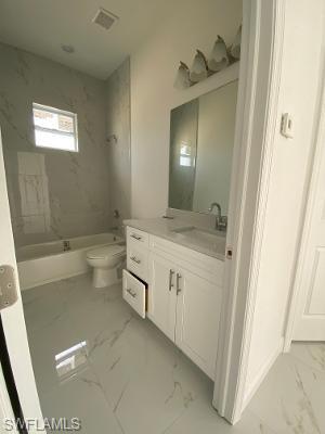 5017 42nd Street Northeast Naples, FL 34120 - Photo 4 of 5 a bathroom with a sink a toilet and shower