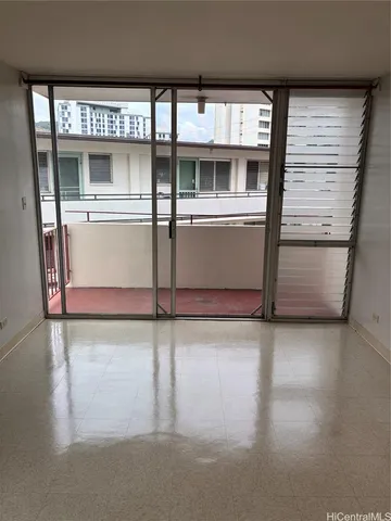 a view of a refrigerator in kitchen and a window