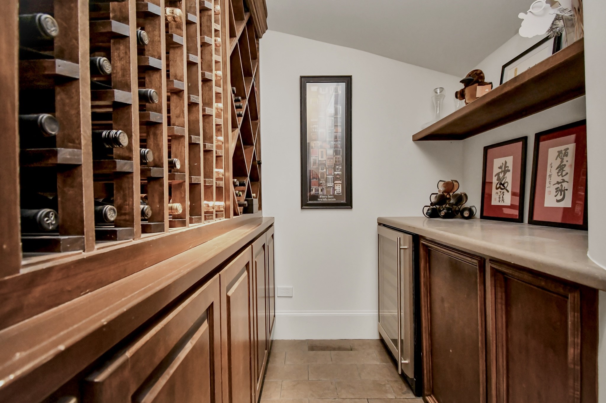 3739 Westerman Street Houston, TX 77005 - Photo 35 of 44 Wine room under the spiral staircase includes a wine refrigerator and plenty of storage.