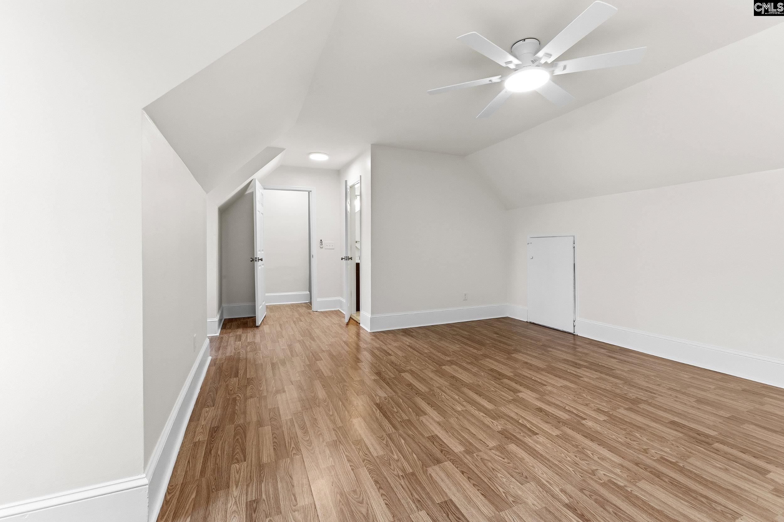121 Silver Lake Road East Columbia, SC 29223 - Photo 26 of 57 an empty room with wooden floor and fan
