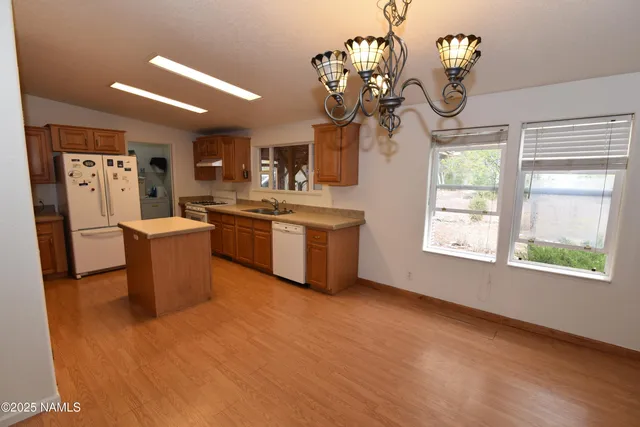 a view of a kitchen with a sink stove and cabinets