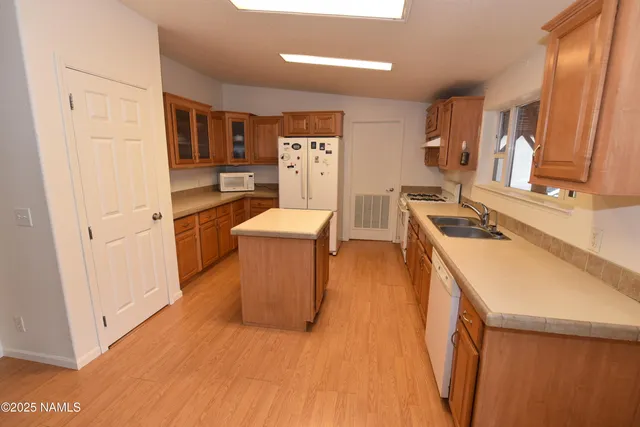 a room with furniture a flat screen tv and a sink