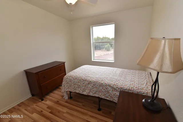 a bed sitting in a bedroom next to a window