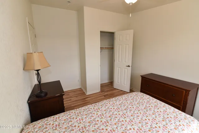 a bedroom with a bed and a lamp