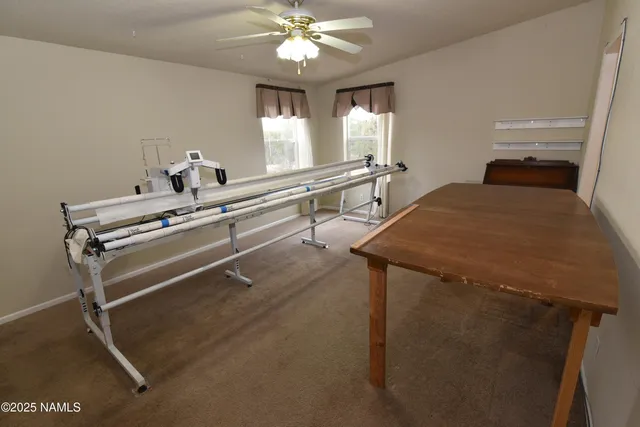 a very nice looking room with a large window and chandelier fan