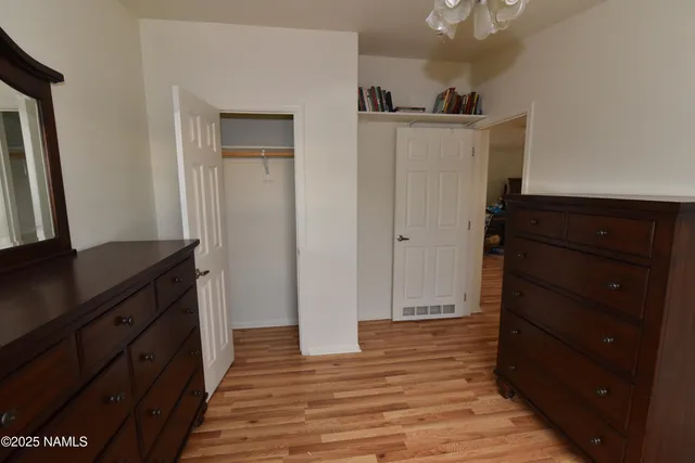 a bedroom with a bed and a dresser