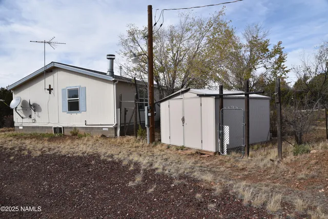 a view of a barn in the middle of a yard