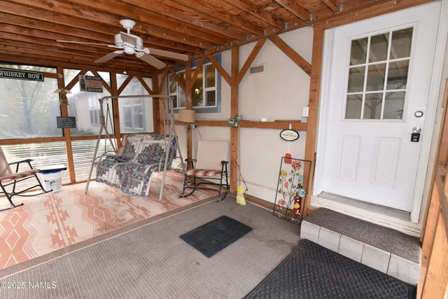a view of an entryway with a table and chairs
