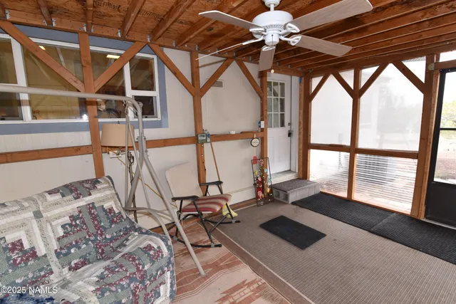 a view of a livingroom with furniture and floor to ceiling windows