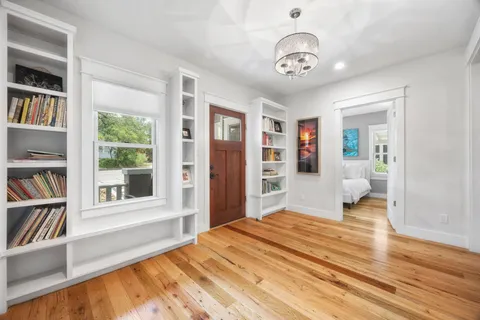 a bedroom with furniture and a book shelf