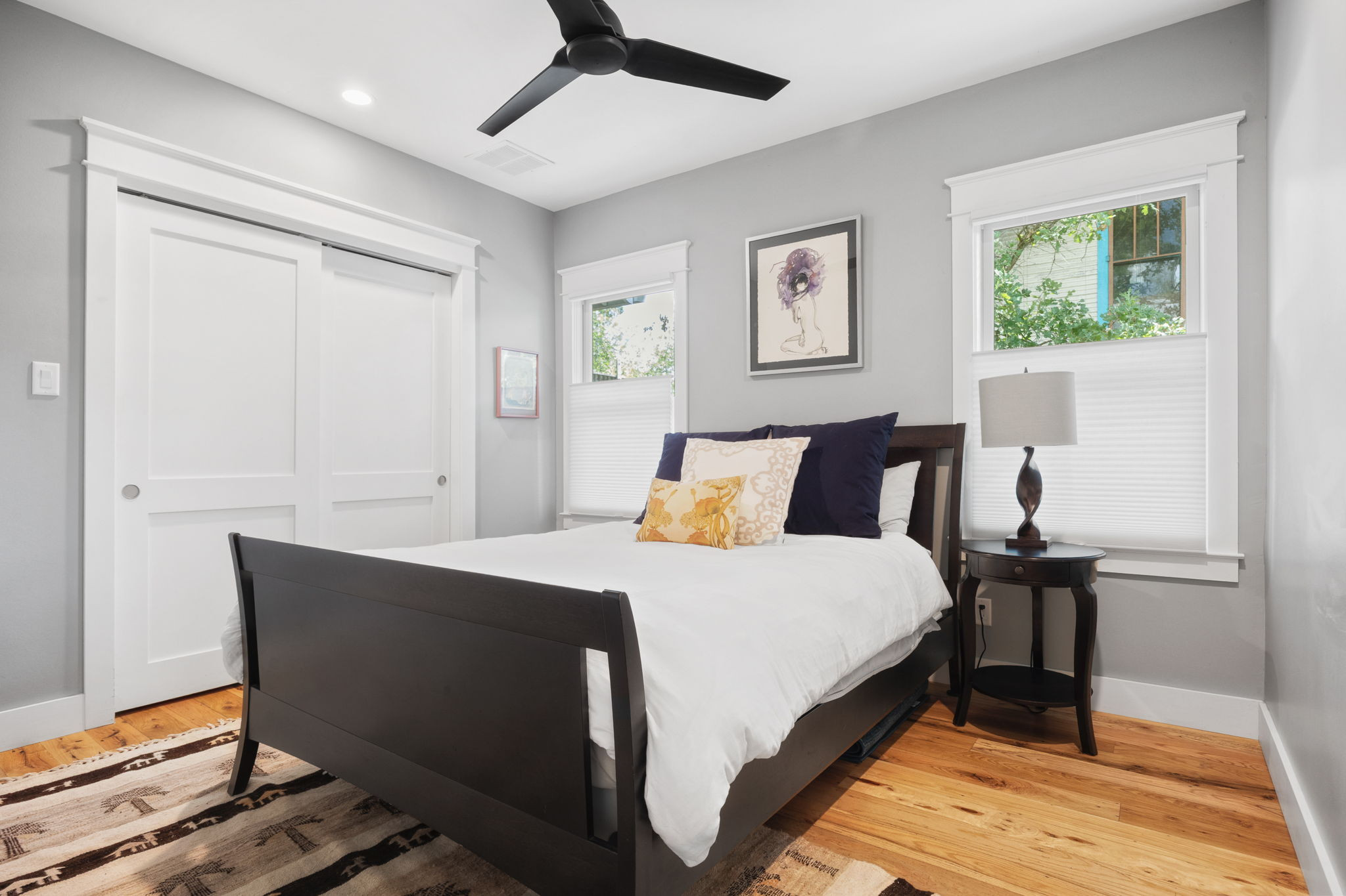 606 East 42nd Street Austin, TX 78751 - Photo 16 of 40 a bedroom with a bed and wooden floor